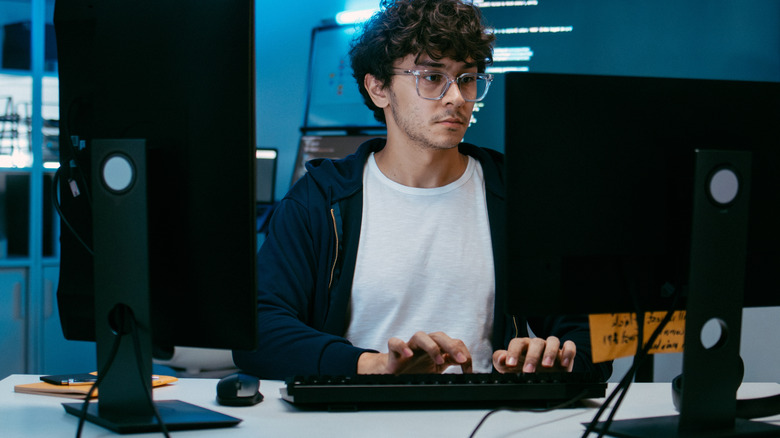man typing at a computer