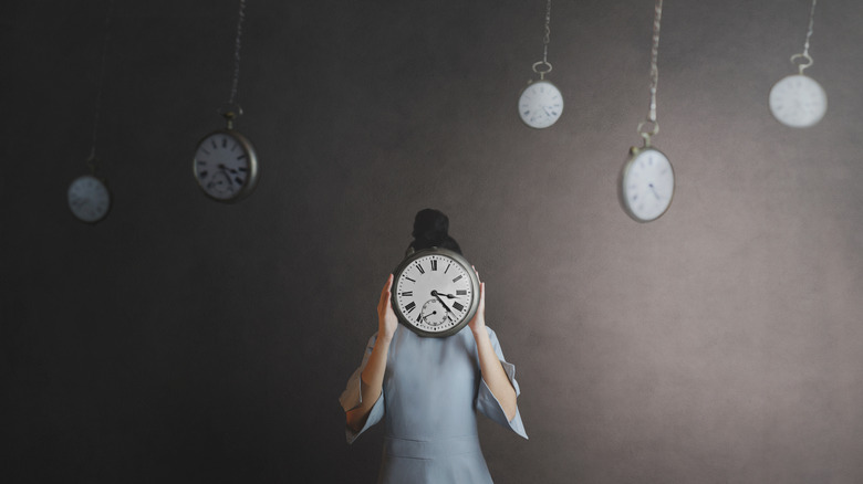 woman holding a clock