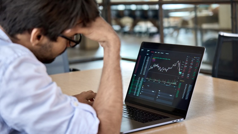 man experimenting with a stock simulator