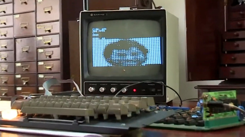 Image of an early Apple Macintosh desktop computer on display