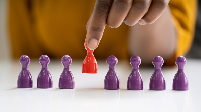 red peg among purple pegs