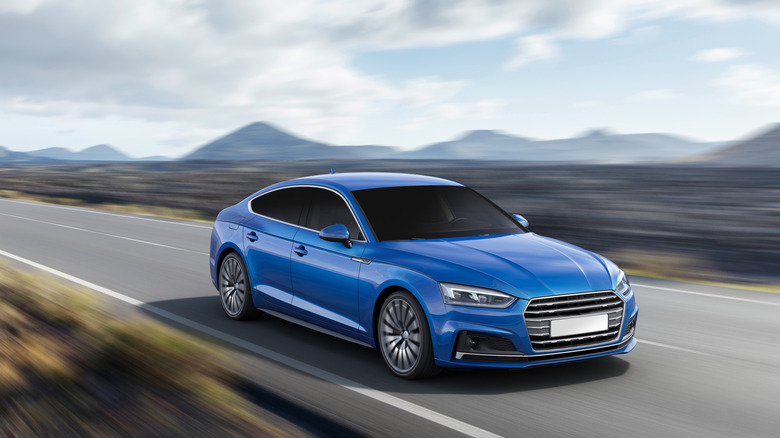 a luxury car driving on a road