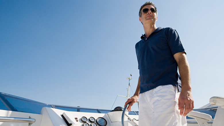 a guy steering a boat