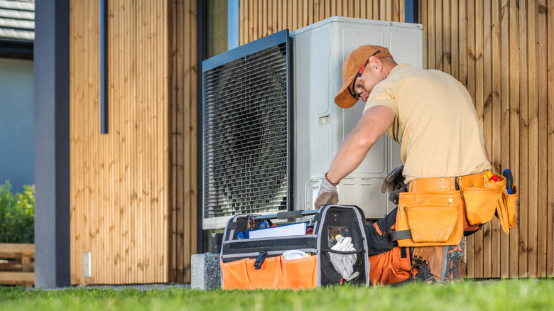HVAC technician working on air conditioner