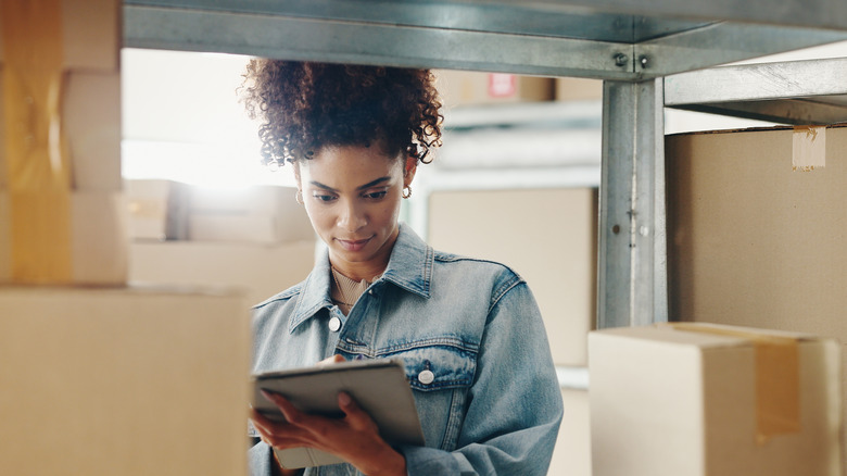 woman checking stock on a shelf