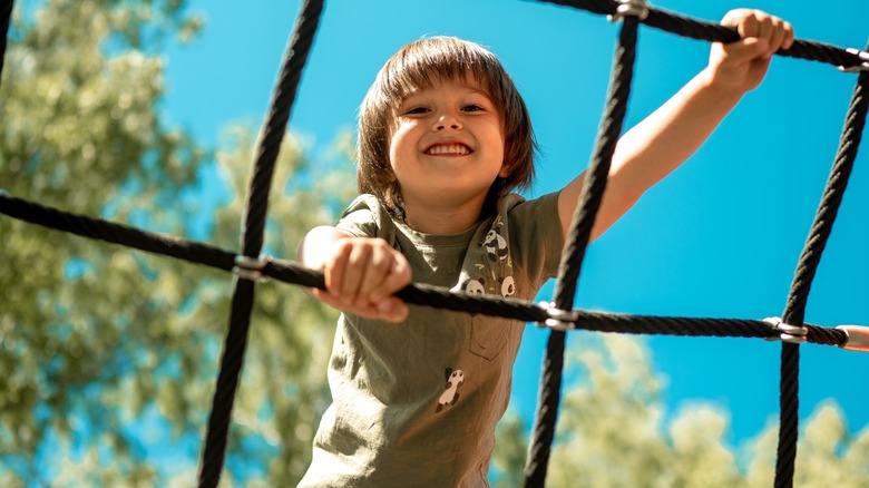 child playing on jungle gym