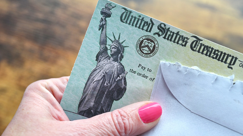 woman opening a social security check letter