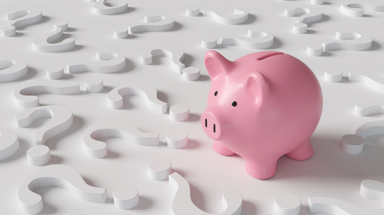 piggy bank and lots of question marks