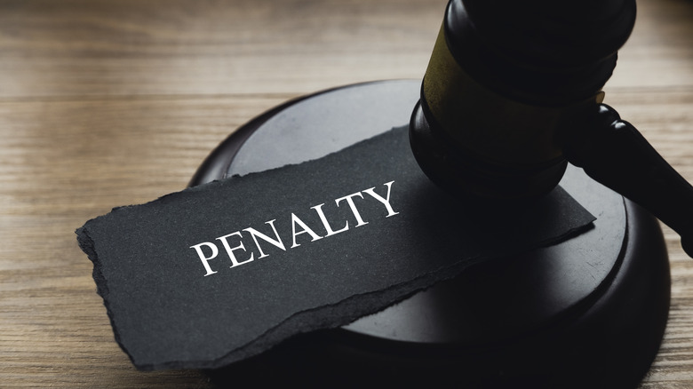 A gavel and a piece of paper written with Penalty.