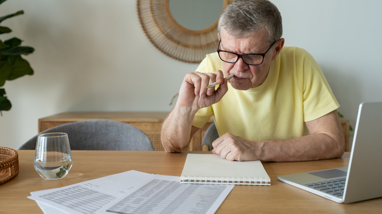 A senior man filling out forms