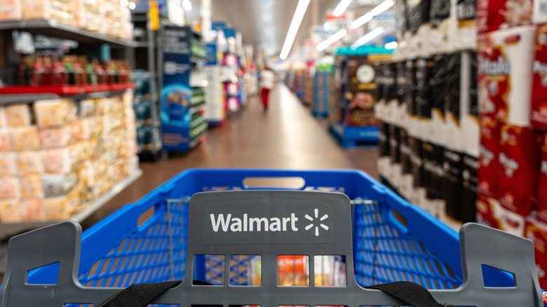 Image of Walmart shopping cart in focus with store background blurred