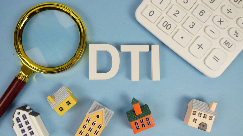 DTI on blue background with small houses, calculator, and magnifying glass