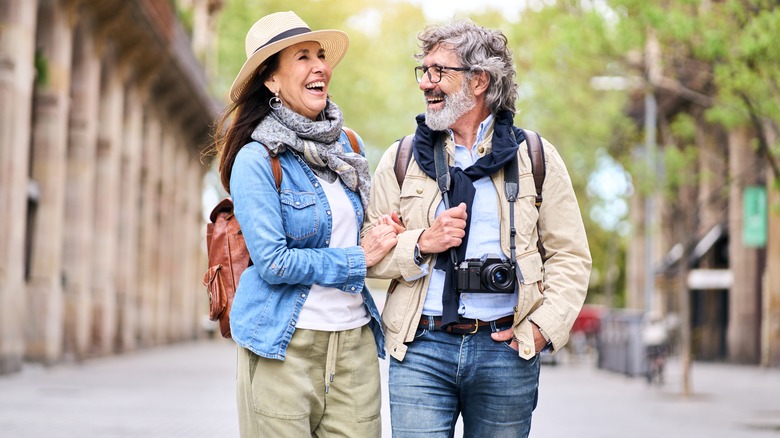 A smiling retired couple walking