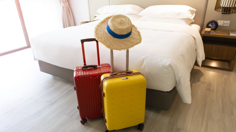 suitcases next to a bed