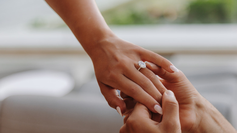 large diamond engagement ring on ring finger