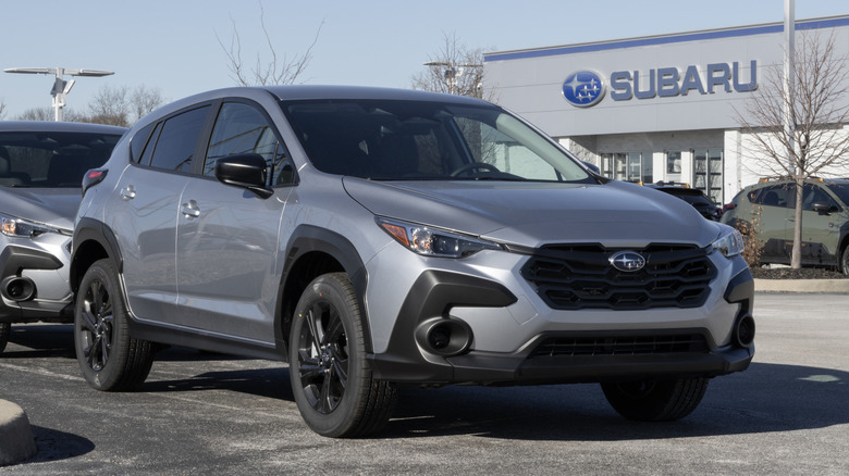 A new Subaru Crosstrek AWD Compact SUV display at a dealership.