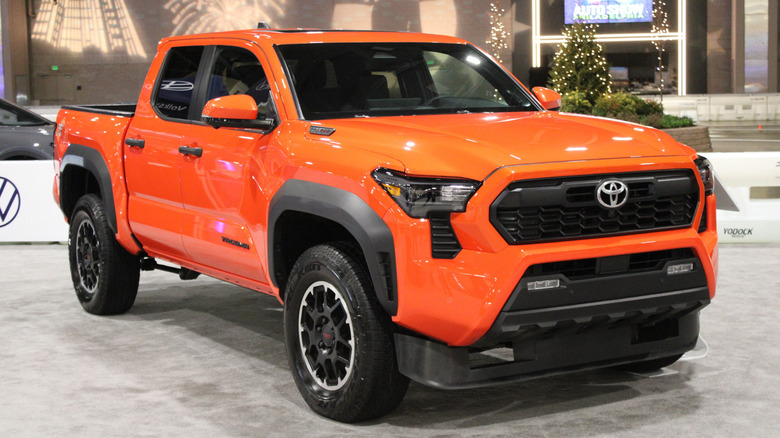 A new orange Toyota Tacoma on display.
