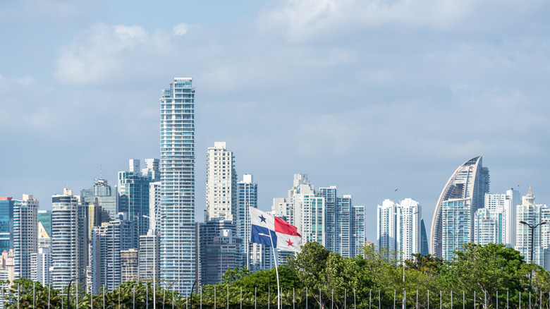 Panama City skyline with Panama flag in foreground