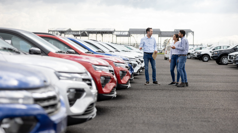 A couple viewing cars at a dealership
