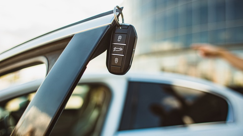 Car keys hanging off a car door