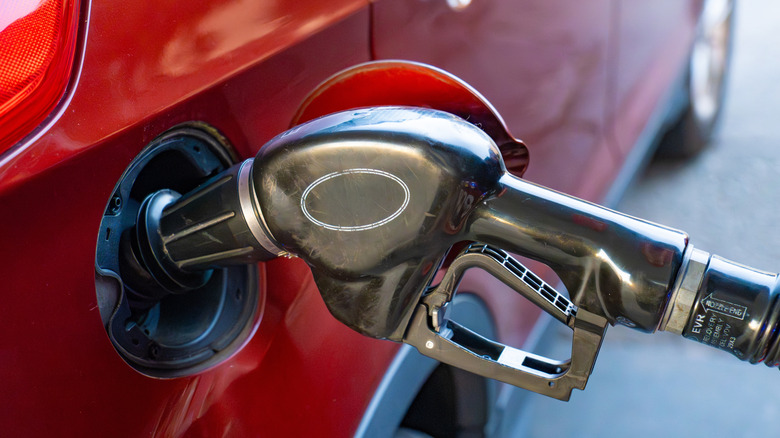 A gas pump nozzle in a car as it gets refueled at a gas station in Santa Cruz, California.