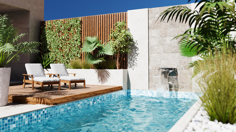 Modern style architecture exterior vacation villa with luxury swimming pool and tropical tree garden.