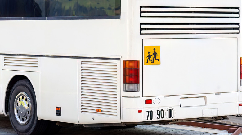 Rear view of a white coach bus.