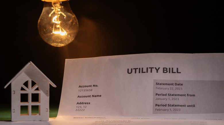 Utility bill and a house with a burning lightbulb.