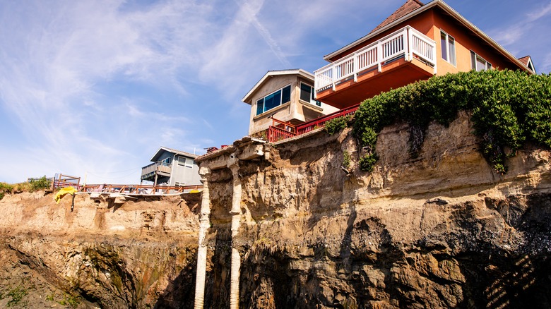 Image of beach houses sitting on a very steep cliff