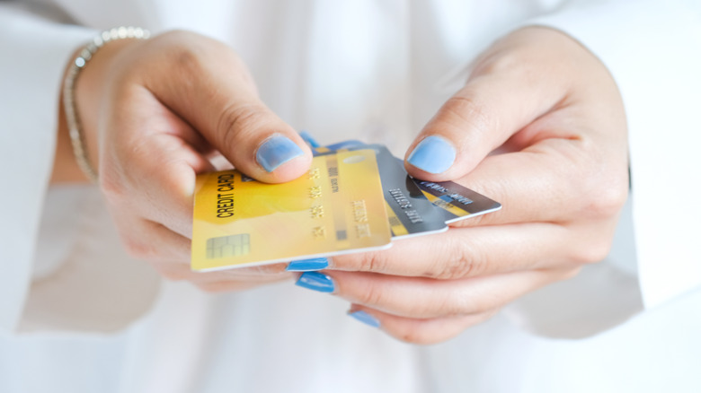 Woman holding multiple credit cards