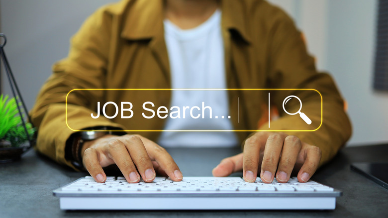 person at keyboard with job search in a bar superimposed overtop