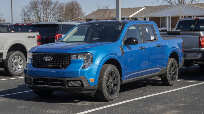 A Ford Maverick XLT AWD Hybrid truck display at a dealership.