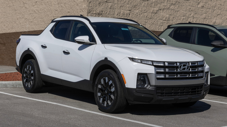 A white Hyundai Santa Cruz on display.
