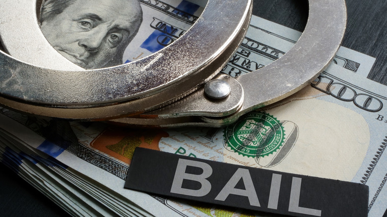 bail, handcuffs, and stack of cash