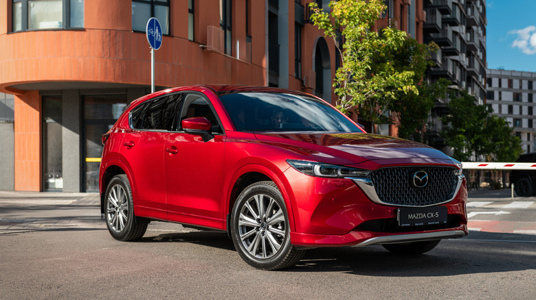 A new red Mazda CX-5 in street of residential district.
