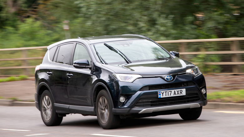 A 2017 Toyota RAV4 SUV driving on a British road.