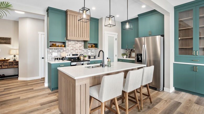well-lit kitchen with a sink in the island