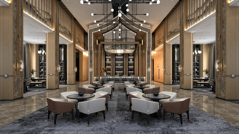 luxury hotel lobby with four-seat tables down the middle
