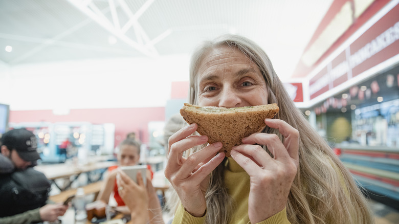woman holding up a sandwich