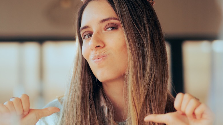 woman pointing at herself