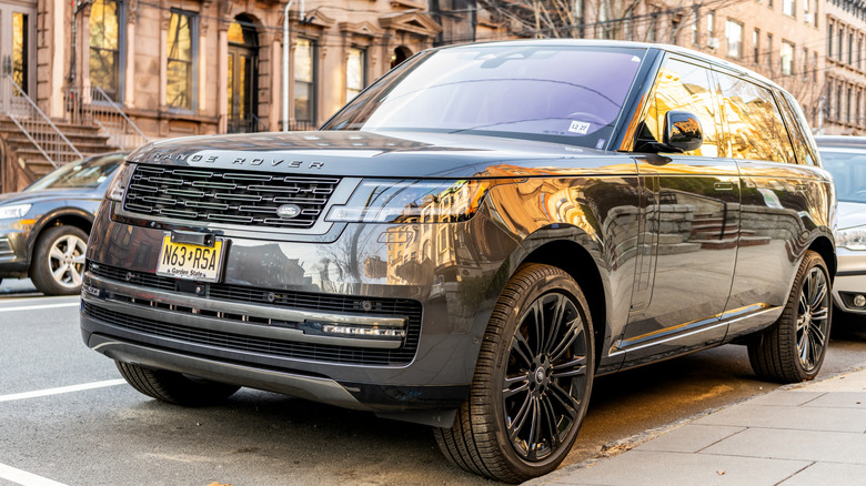 Land Rover Range Rover Evoque parked in front of brownstone homes