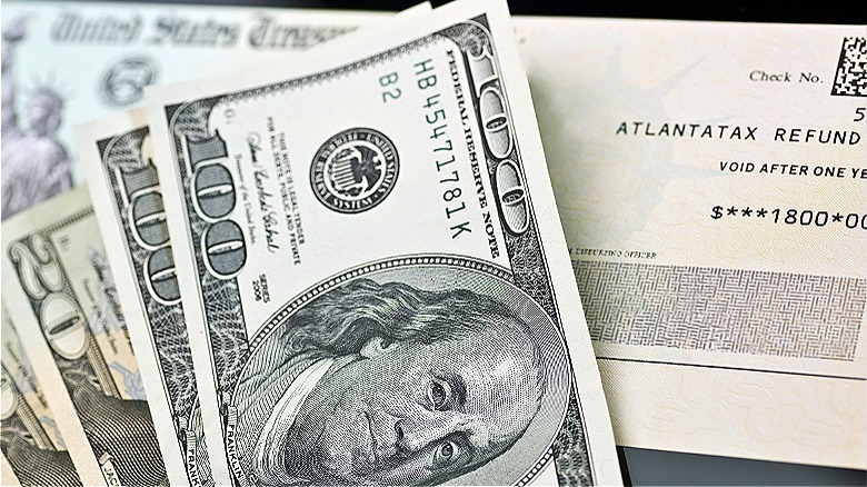 Tax refund check and cash