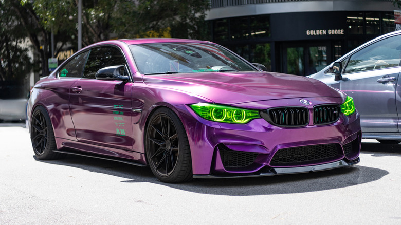 Purple BMW M4 sport car on display.