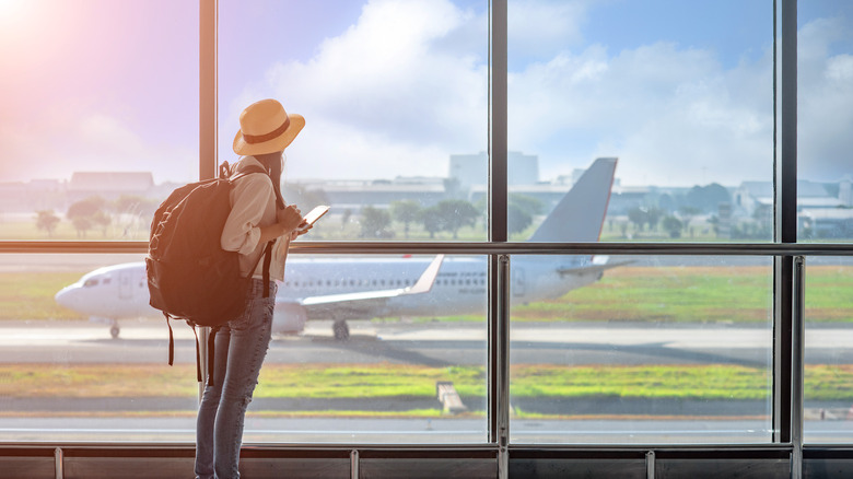 A woman looking at a plane