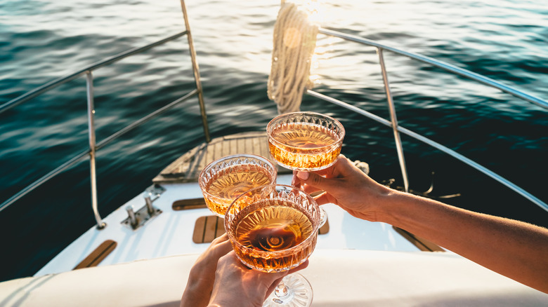 friends drinking champagne in a boat