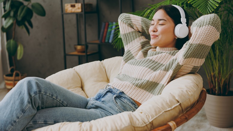 woman relaxing while wearing headphones