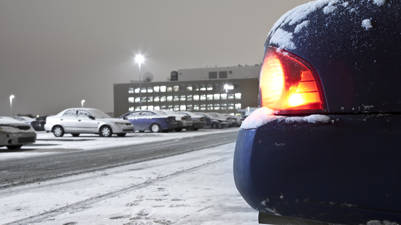 A car parked in a parking lot with lights on