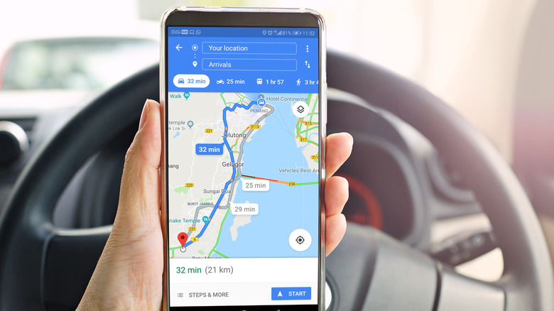A hand holding a phone with Google Maps displayed