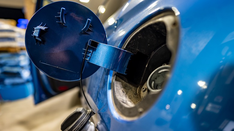 An open gas cap lid