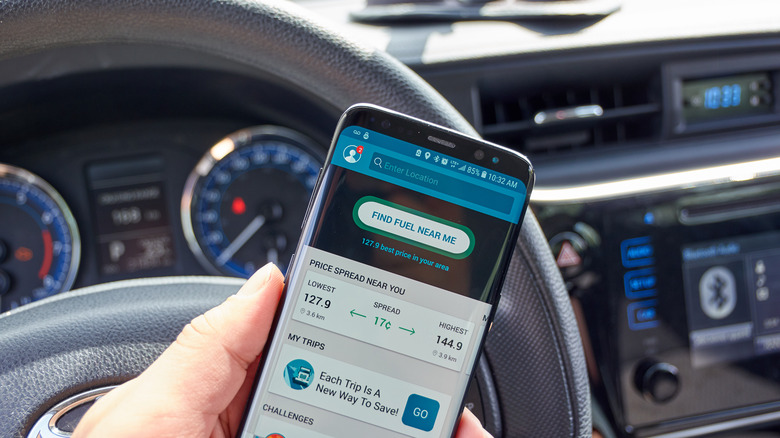 A hand holding a phone running an app